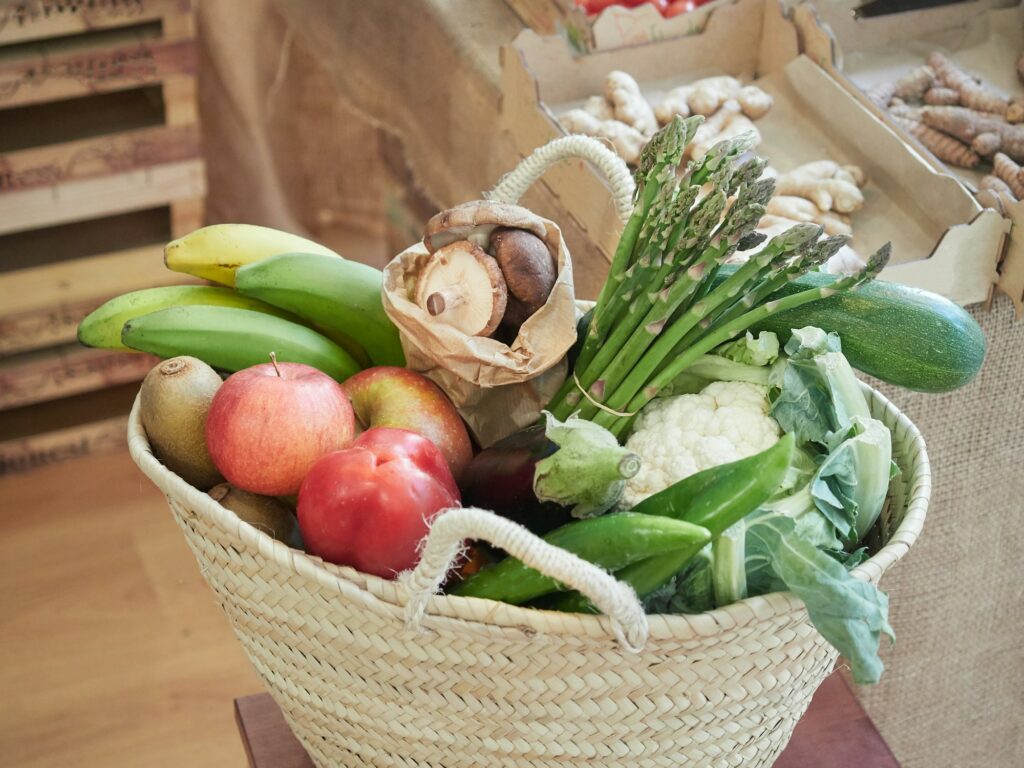 Wicker basket full of vegetables and fruits.